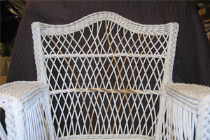 A wicker couch with repaired back